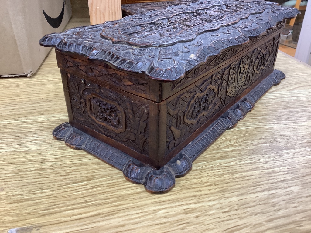 Two 19th century Chinese carved sandalwood boxes, together with a similar puzzle box, length 27cm